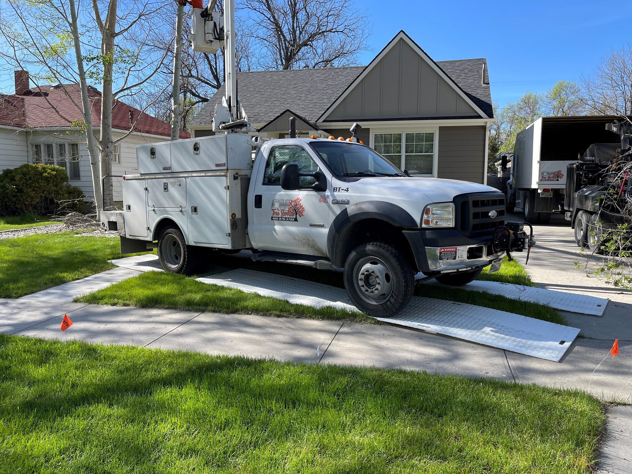 Tree trimmers using ground protection mats