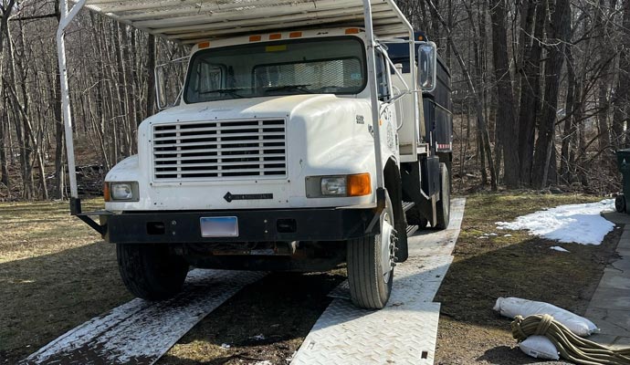 White truck on the ground protection mats